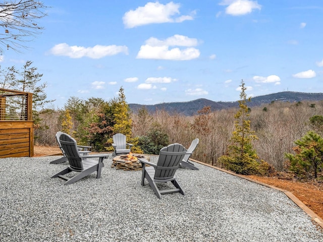 view of patio / terrace with a mountain view and a fire pit