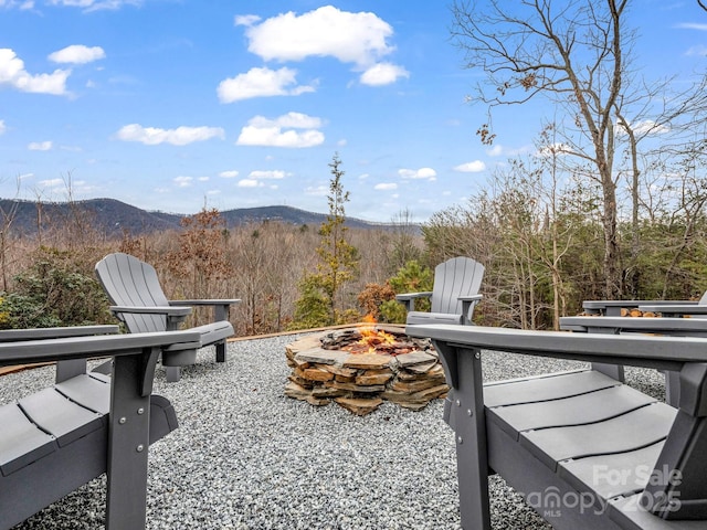 view of patio / terrace featuring a mountain view and an outdoor fire pit