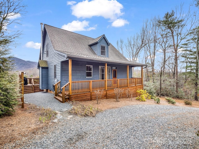 view of front facade with a mountain view and covered porch