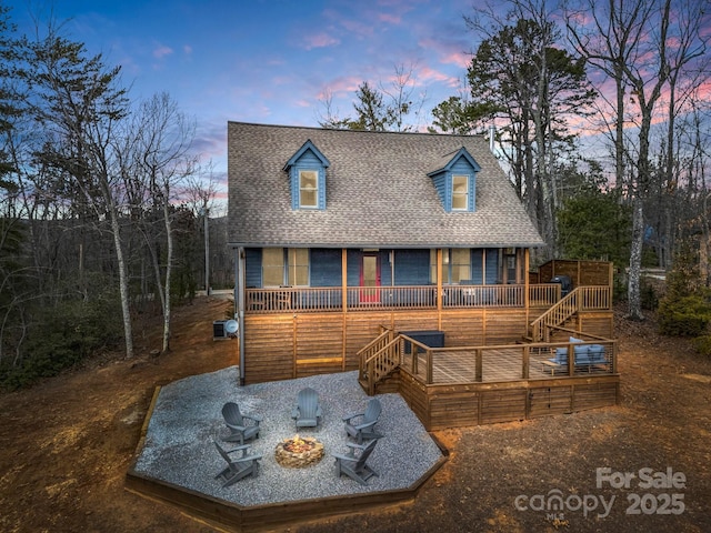 view of front facade featuring a deck and a fire pit