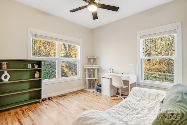 living area with hardwood / wood-style flooring and ceiling fan