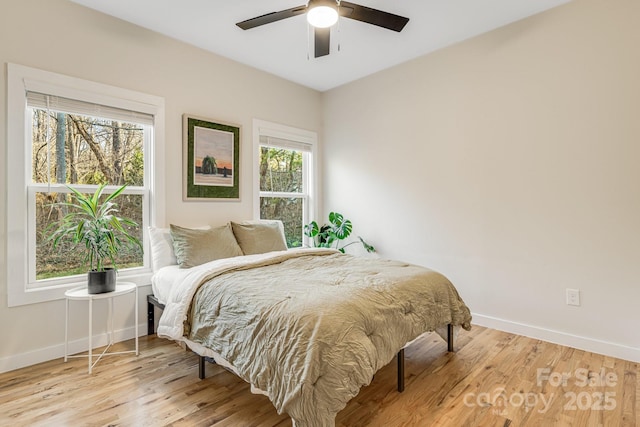 bedroom with ceiling fan and light wood-type flooring