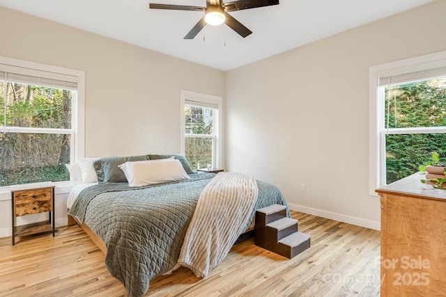 bedroom with ceiling fan and light hardwood / wood-style flooring