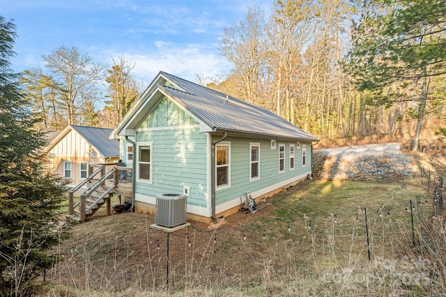 view of side of home with central air condition unit