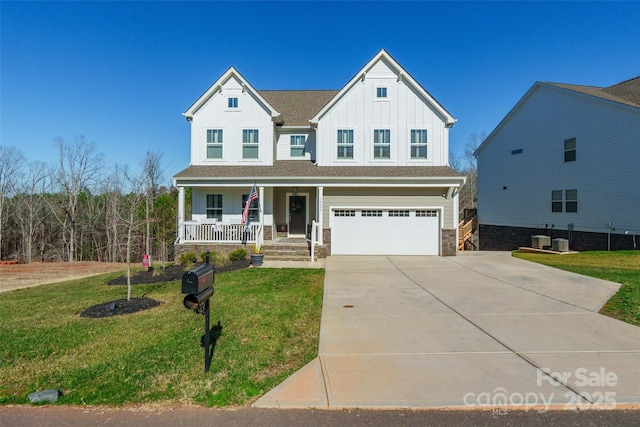 view of front facade featuring a front lawn, a garage, a porch, and central air condition unit