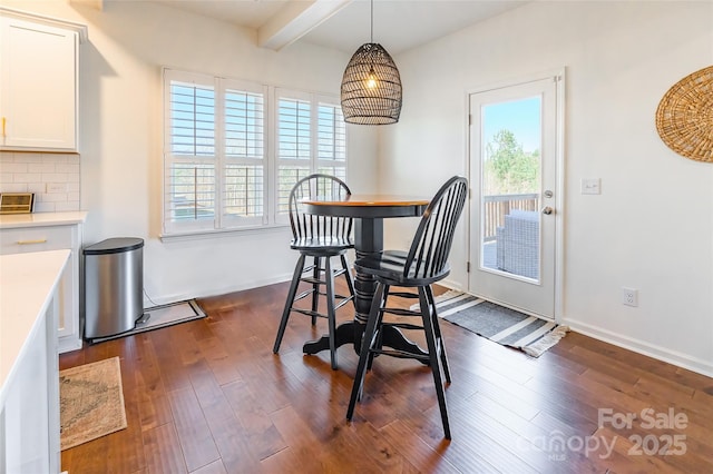 dining room with baseboards, dark wood-type flooring, and beamed ceiling