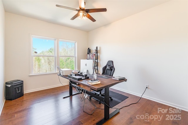 office area with ceiling fan, dark wood finished floors, and baseboards