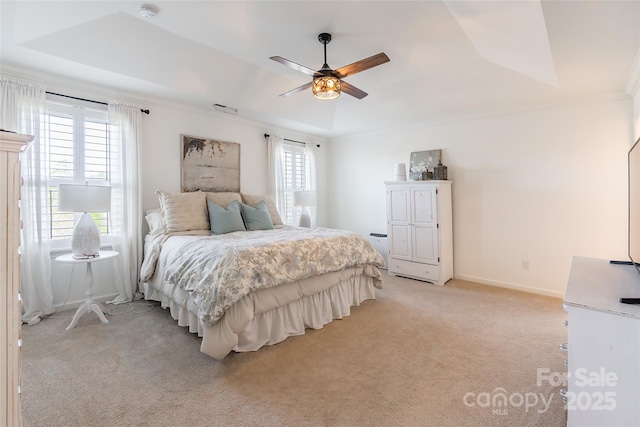 bedroom with light carpet, baseboards, visible vents, a raised ceiling, and ornamental molding