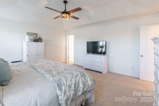 bedroom with crown molding, a raised ceiling, light colored carpet, ceiling fan, and baseboards