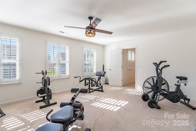 workout room with light carpet, a ceiling fan, visible vents, and baseboards