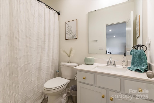 bathroom featuring toilet and vanity