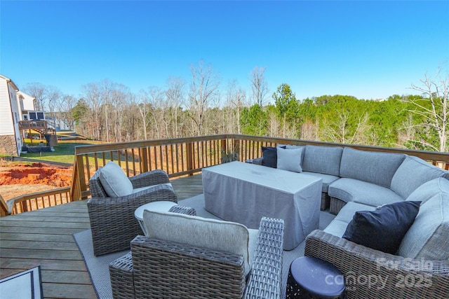 wooden terrace with an outdoor hangout area