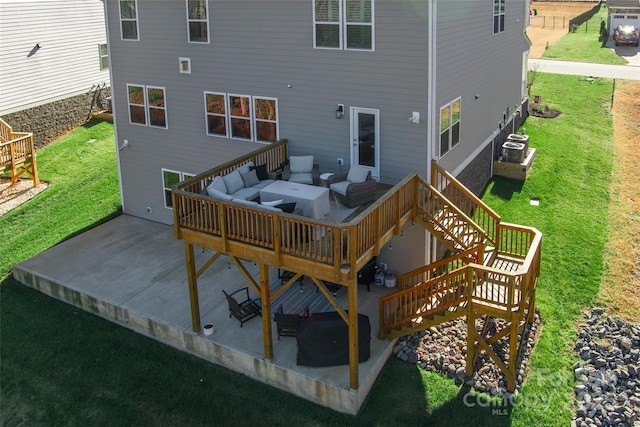 back of property with stairway, cooling unit, a yard, a patio area, and outdoor lounge area