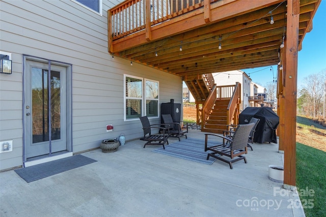 view of patio with stairs, a deck, and area for grilling