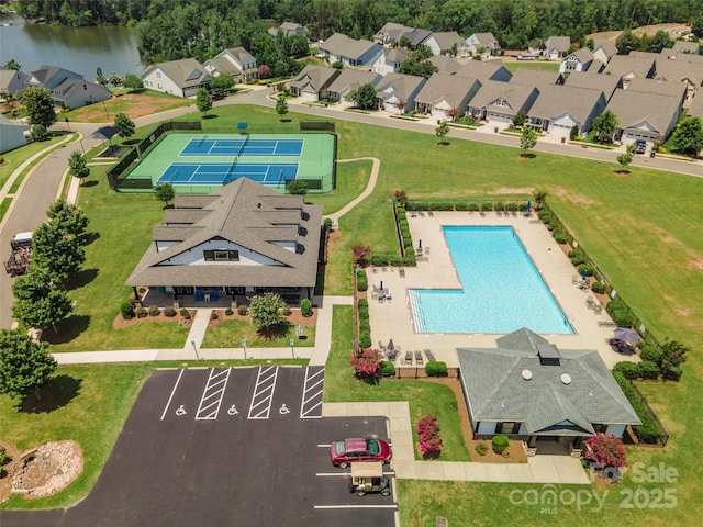 drone / aerial view with a water view and a residential view