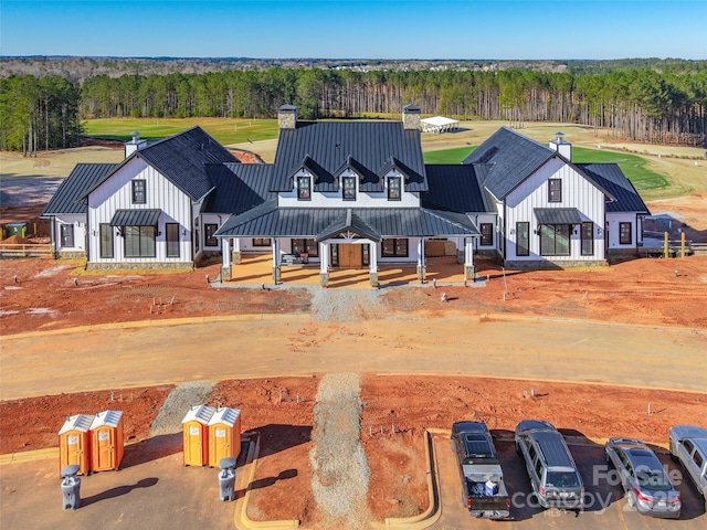 birds eye view of property with a view of trees