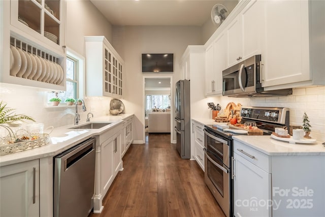 kitchen featuring dark hardwood / wood-style floors, sink, stainless steel appliances, and white cabinetry