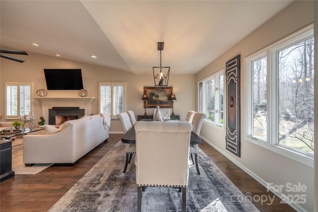 dining space with vaulted ceiling and dark hardwood / wood-style floors