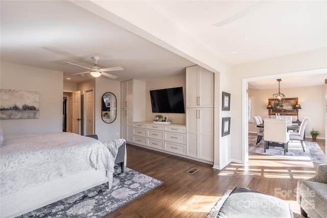 bedroom with ceiling fan and dark hardwood / wood-style flooring