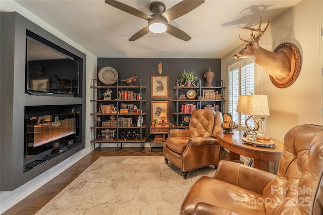 sitting room featuring ceiling fan and wood-type flooring