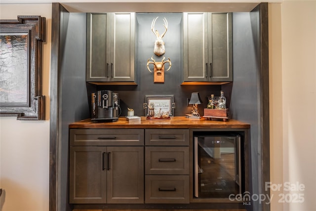 bar featuring wine cooler, butcher block counters, and gray cabinets