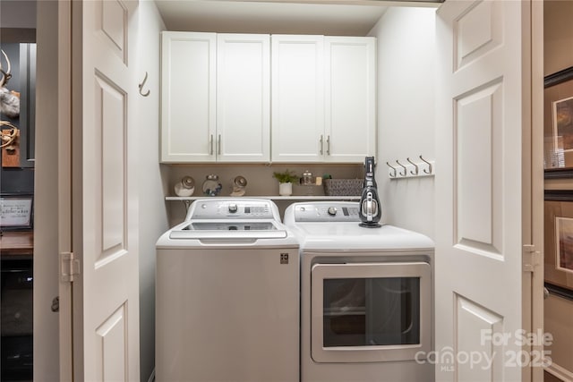 laundry area featuring cabinets and independent washer and dryer