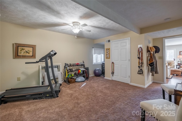 workout room with carpet floors, ceiling fan, and a textured ceiling