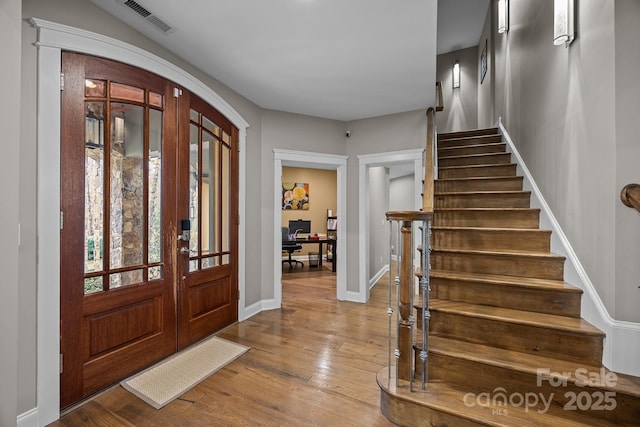 entryway with hardwood / wood-style flooring and french doors