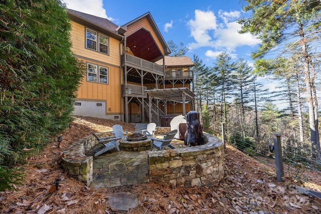 view of yard featuring an outdoor fire pit, a balcony, and a patio