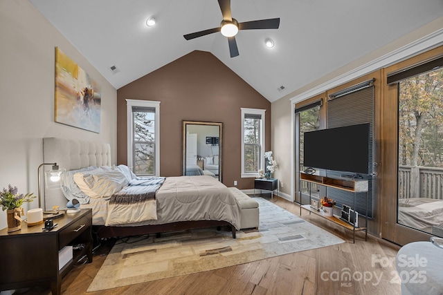 bedroom with vaulted ceiling, ceiling fan, and light hardwood / wood-style floors