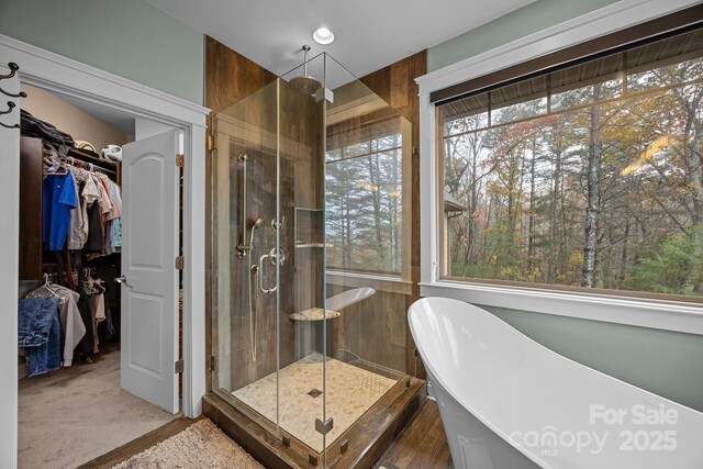 bathroom featuring shower with separate bathtub