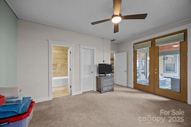 carpeted bedroom featuring ceiling fan, access to exterior, connected bathroom, and french doors