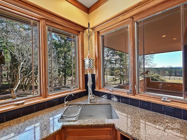 interior details featuring sink and light stone counters