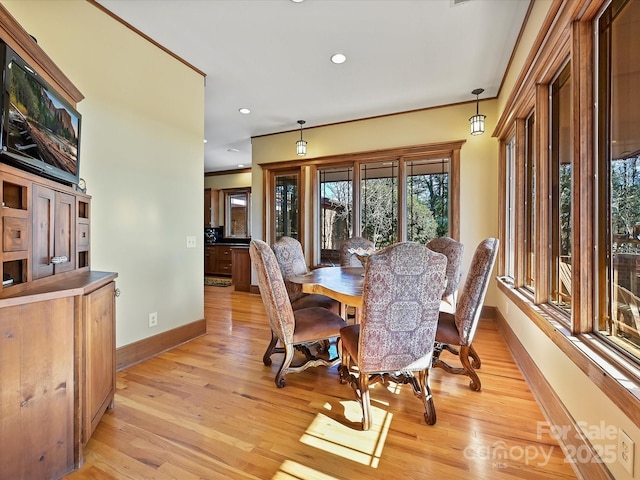 dining space with light hardwood / wood-style floors