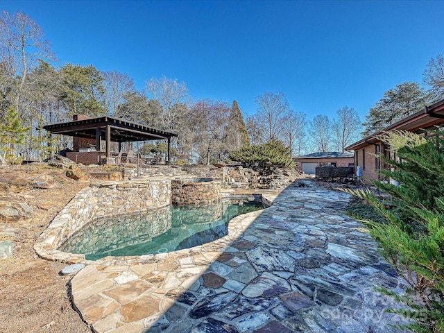 view of pool featuring an in ground hot tub and a patio area