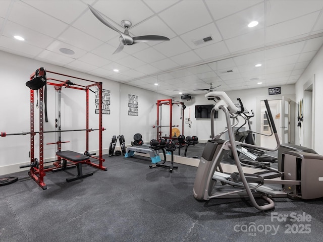 gym with ceiling fan and a drop ceiling