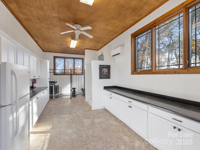 kitchen featuring white cabinetry, white fridge, and wooden ceiling