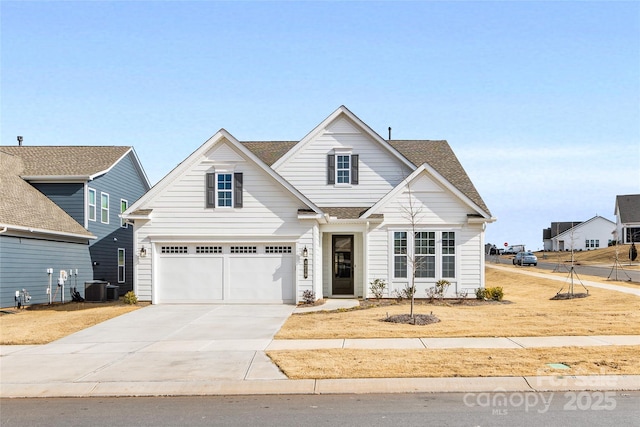 view of front of house with a garage and central air condition unit