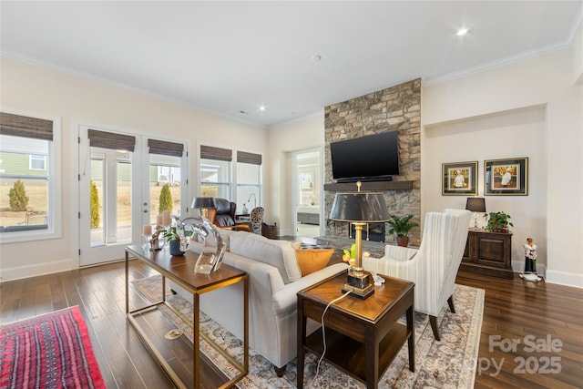 living room featuring ornamental molding, dark wood-type flooring, a fireplace, and french doors