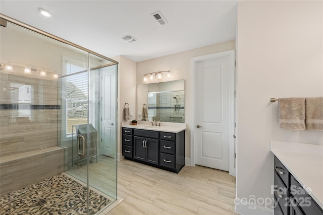 bathroom featuring vanity and an enclosed shower