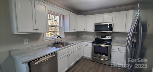 kitchen with white cabinets, appliances with stainless steel finishes, and sink