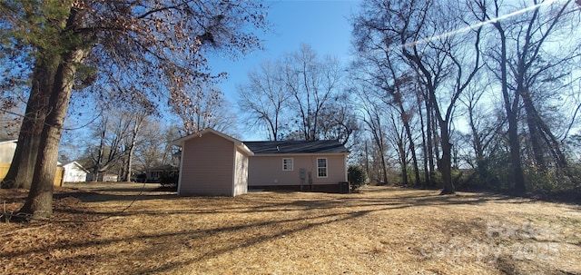 rear view of house featuring a yard