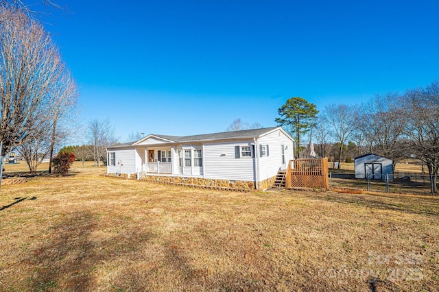 back of house with a deck and a lawn