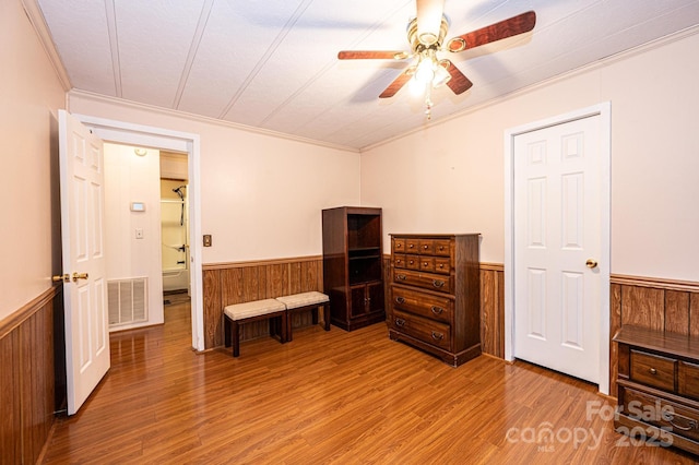 bedroom with hardwood / wood-style floors, crown molding, a textured ceiling, and ceiling fan