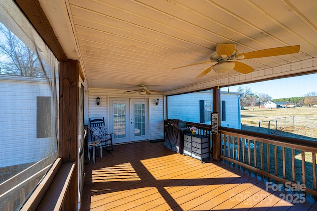 deck with french doors and ceiling fan