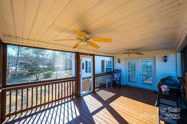 wooden deck featuring french doors and ceiling fan