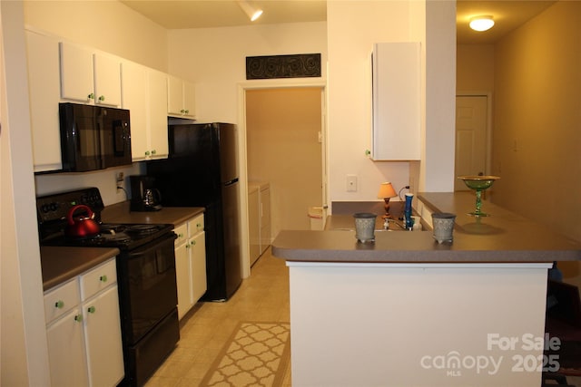 kitchen with washer and clothes dryer, white cabinets, black appliances, and kitchen peninsula