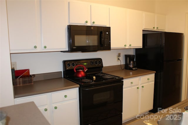 kitchen with black appliances and white cabinets