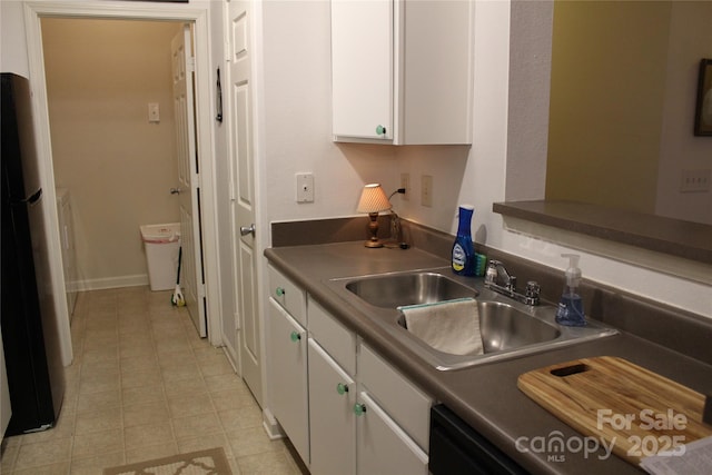 kitchen featuring sink, white cabinets, dishwasher, and fridge