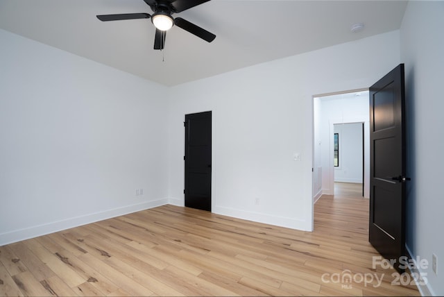 spare room with ceiling fan and light hardwood / wood-style flooring